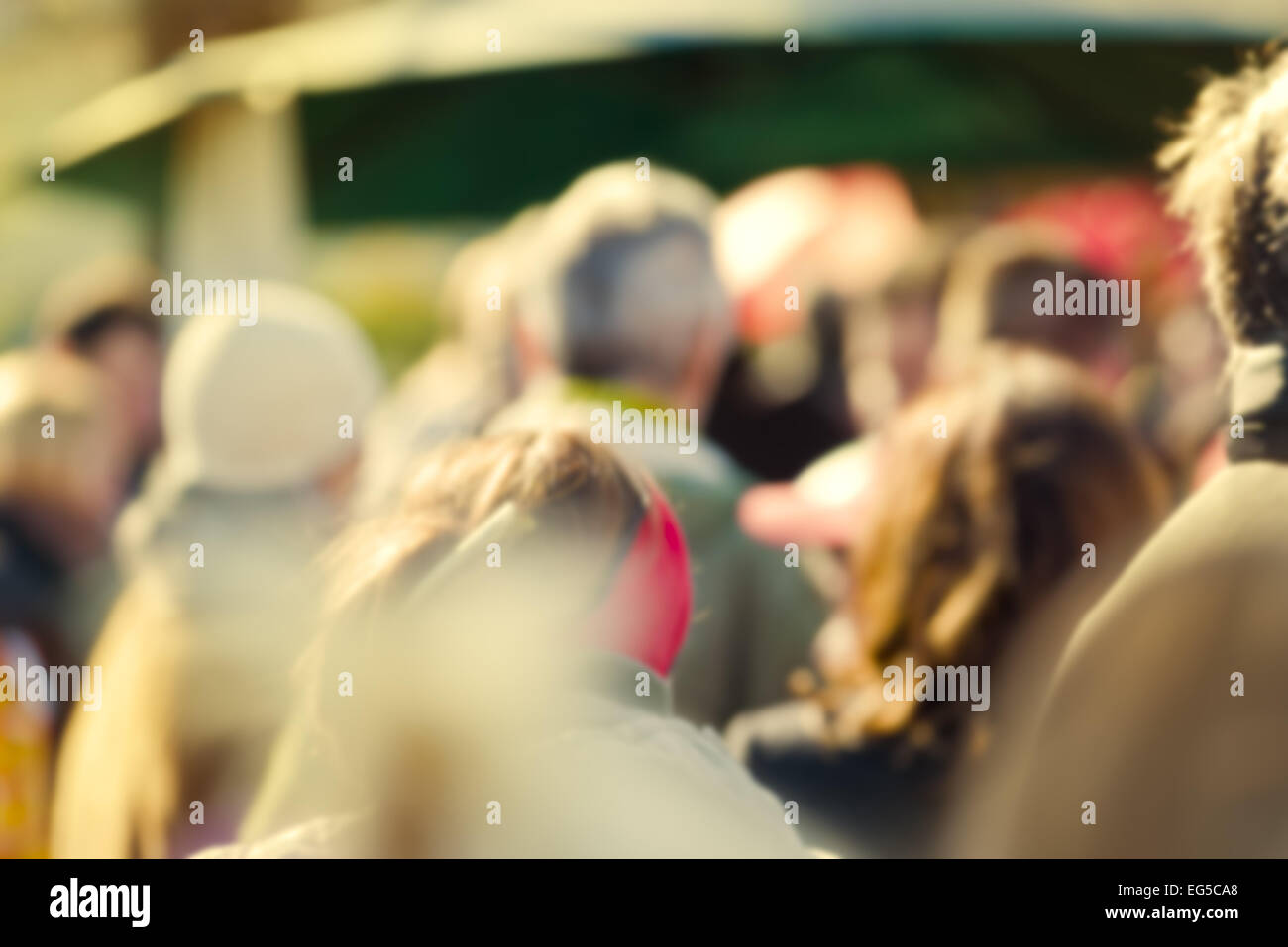 Crowd of People Walking On the Street in Bokeh, unrecognizable group of men and women as blur urban background. Stock Photo