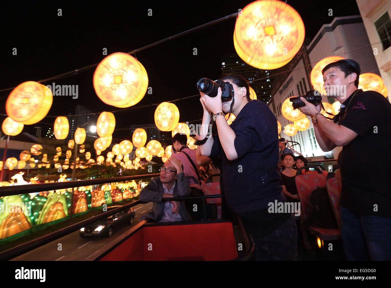 Members of the media on the tour of the Chinatown lightup take photographs of the gold coin lanterns as part of the visual display. Organised by the Kreta Ayer-Kim Seng Citizens' Consultative Committee, 338 goat-shaped lanterns - the most number of zodiac lanterns ever made - and 1500 gold coins lanterns will take centre stage in this year's street decorations that will light up the Chinatown precinct from January 31 to March 19, 2015. Stock Photo