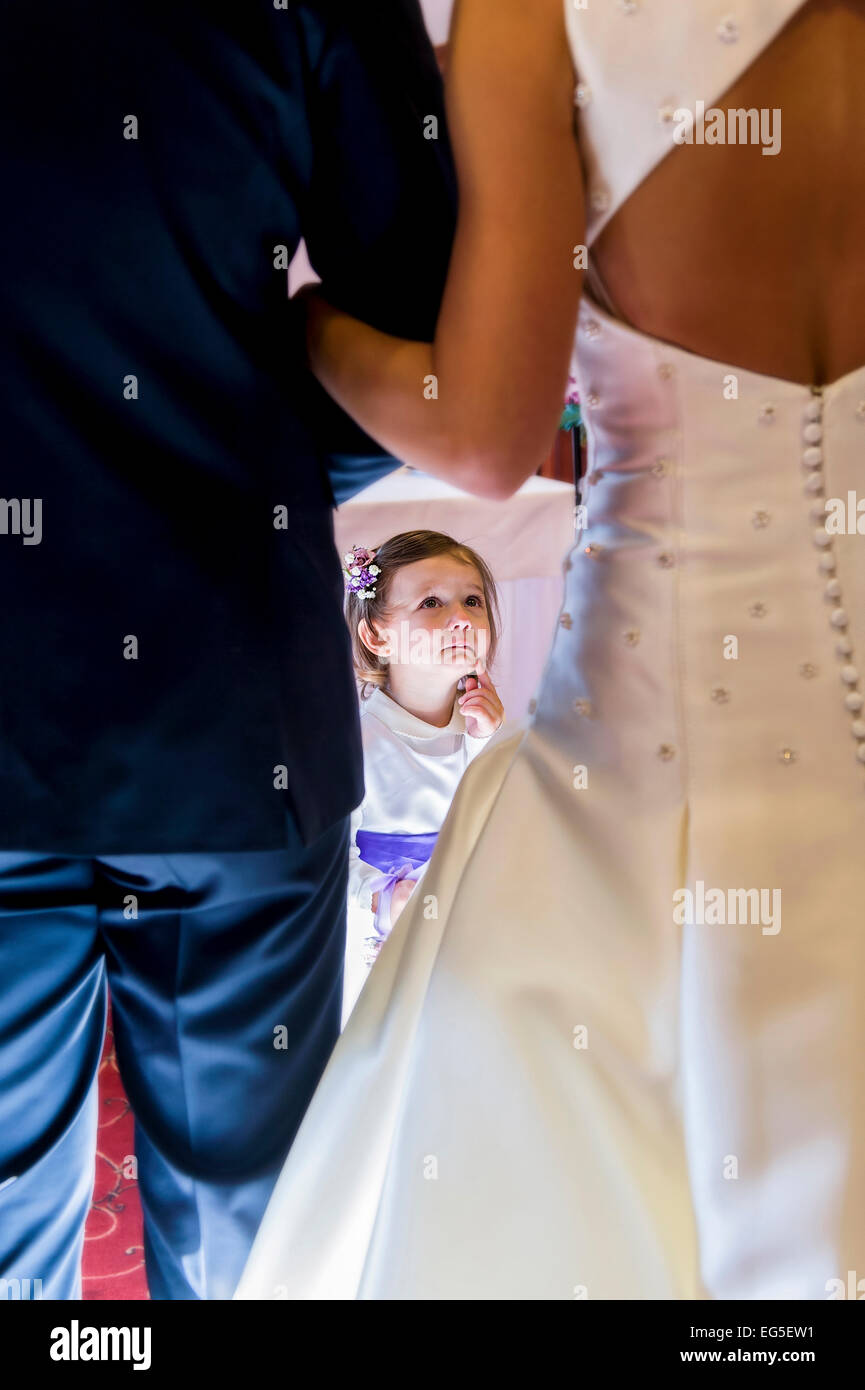 baby girl bridesmaid looking at bride during wedding ceremony Stock Photo