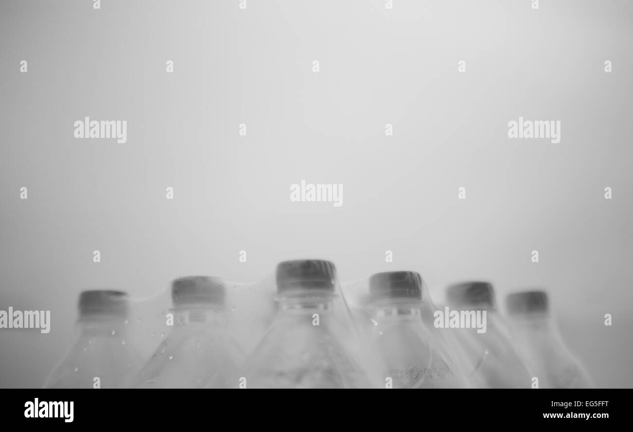 Bottles covered with plastic stand in formations and military discipline. This shows team work, discipline. Stock Photo