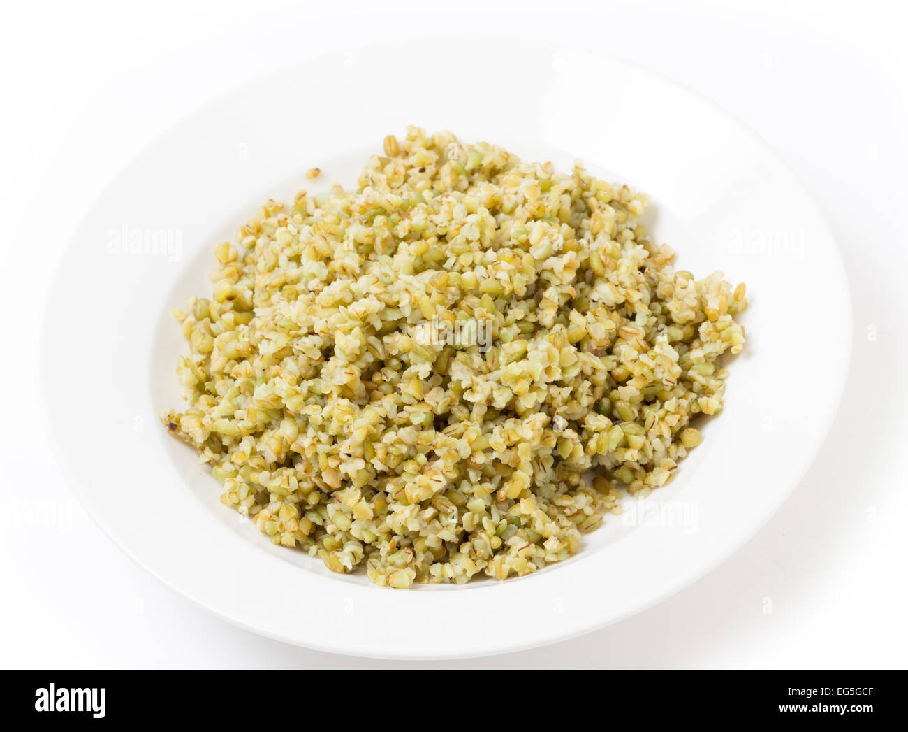 A bowl of freshly boiled cracked freekeh scorched green wheat grains, one of the 'paleo superfoods'. It can be eaten as it is or Stock Photo