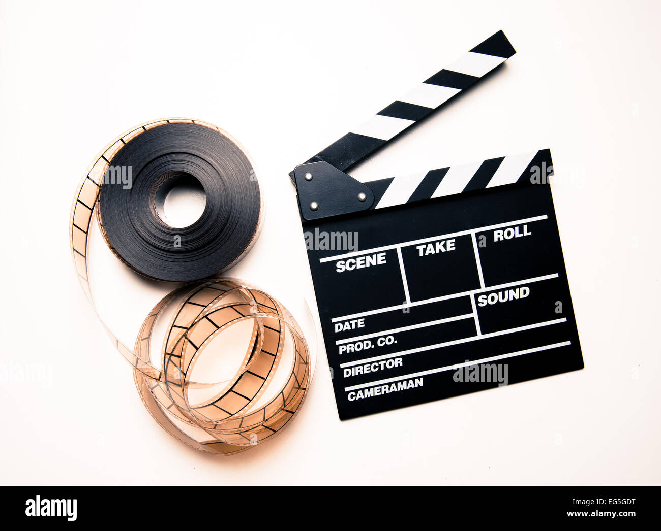 Unrolled 35mm movie reel and clapperboard on right side in vintage color  effect Stock Photo - Alamy