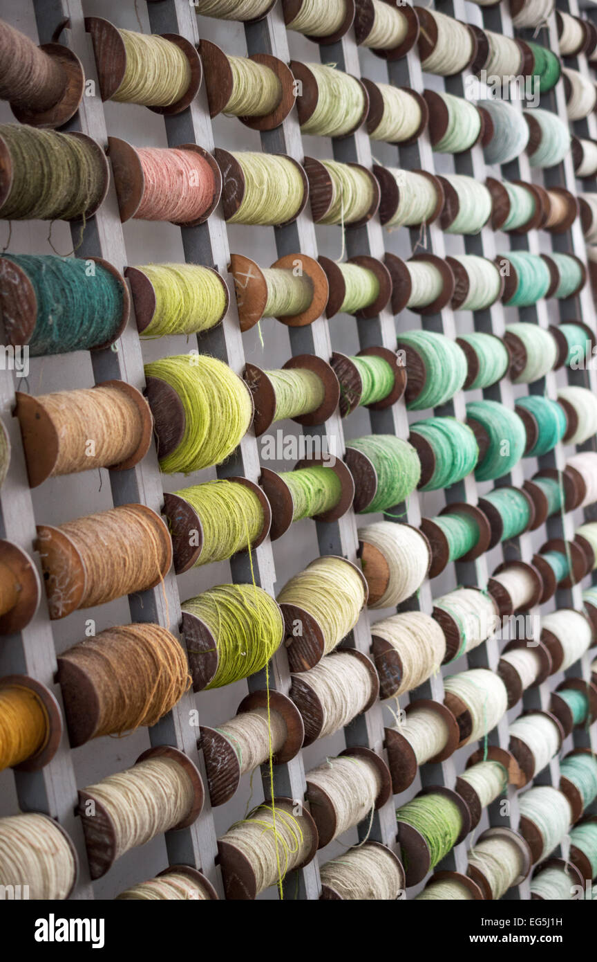 Spools of coloured threads on display in a Chinese carpet making factory Stock Photo