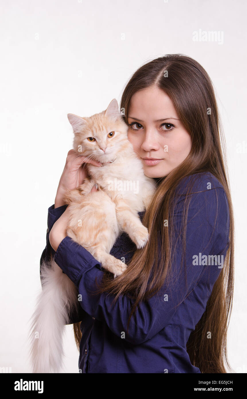 Portrait of a beautiful young woman of the European type on a white background with a cat Stock Photo