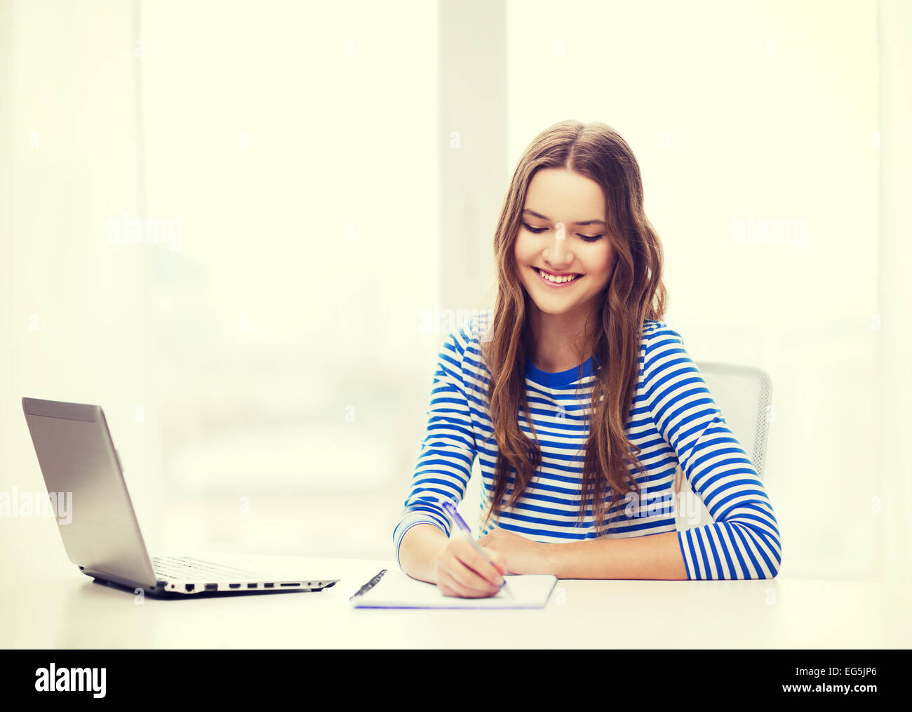 smiling teenage girl laptop computer and notebook Stock Photo - Alamy