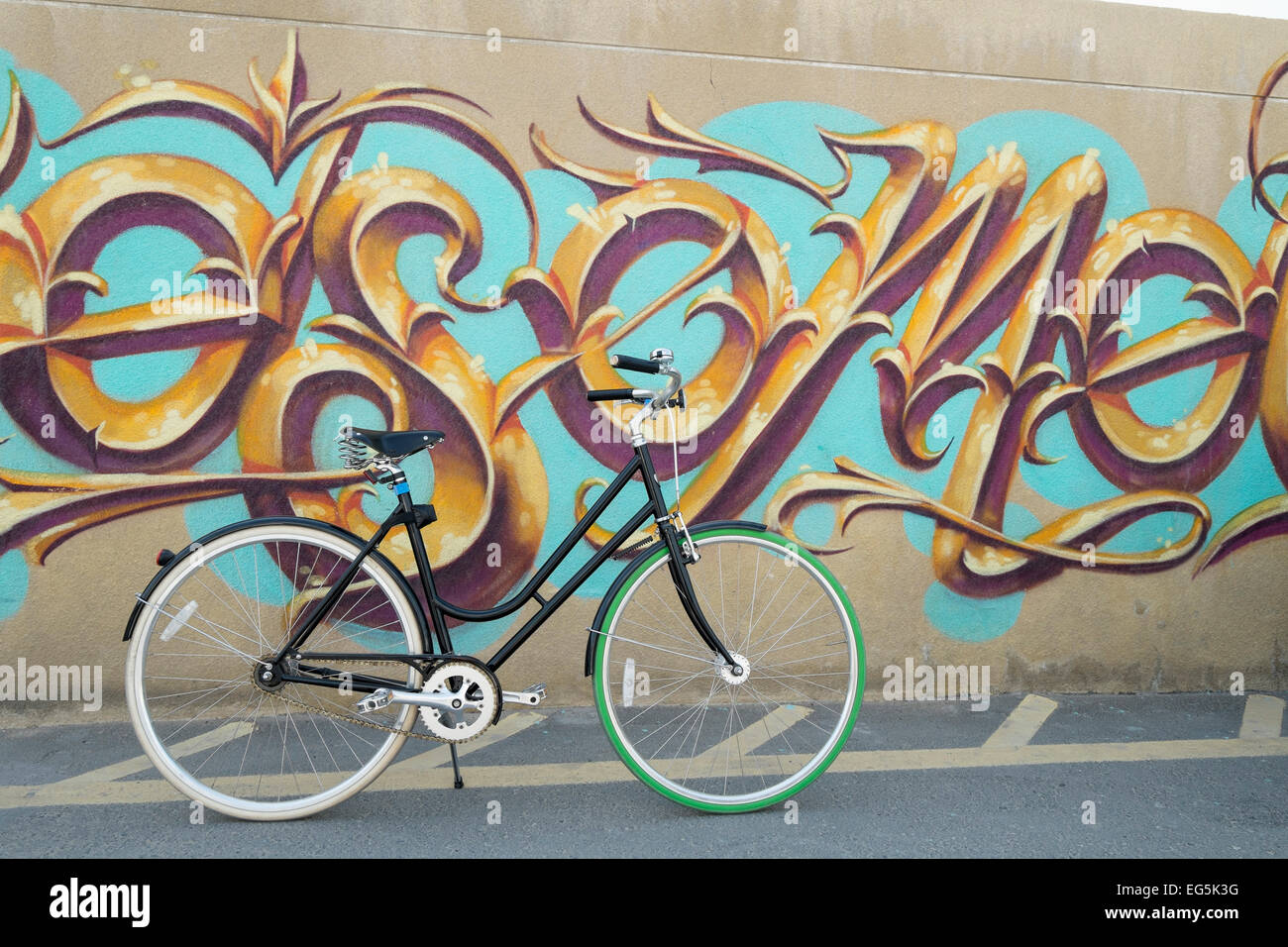 Bicycle and graffiti on wall at Alserkal Avenue art district in Al Quoz Dubai United Arab Emirates Stock Photo