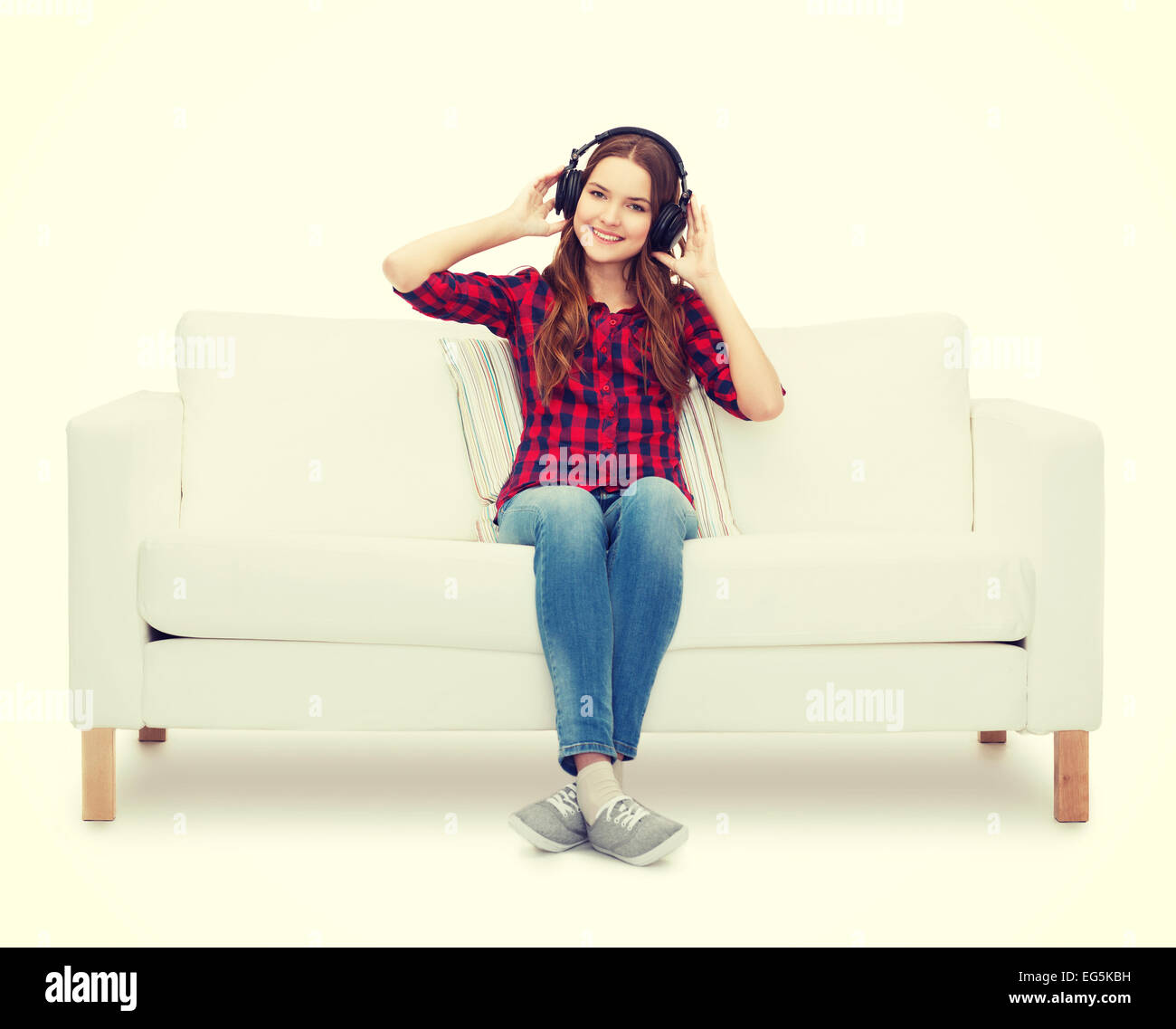 teenage girl sitting on sofa with headphones Stock Photo - Alamy