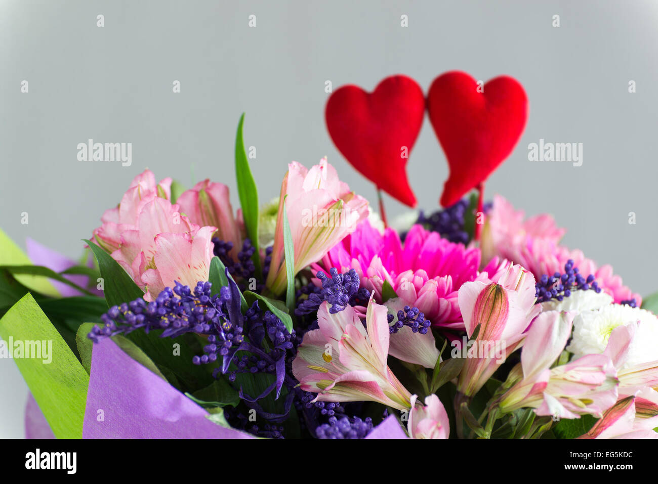 Red hearts and a bouquet of flowers Stock Photo - Alamy