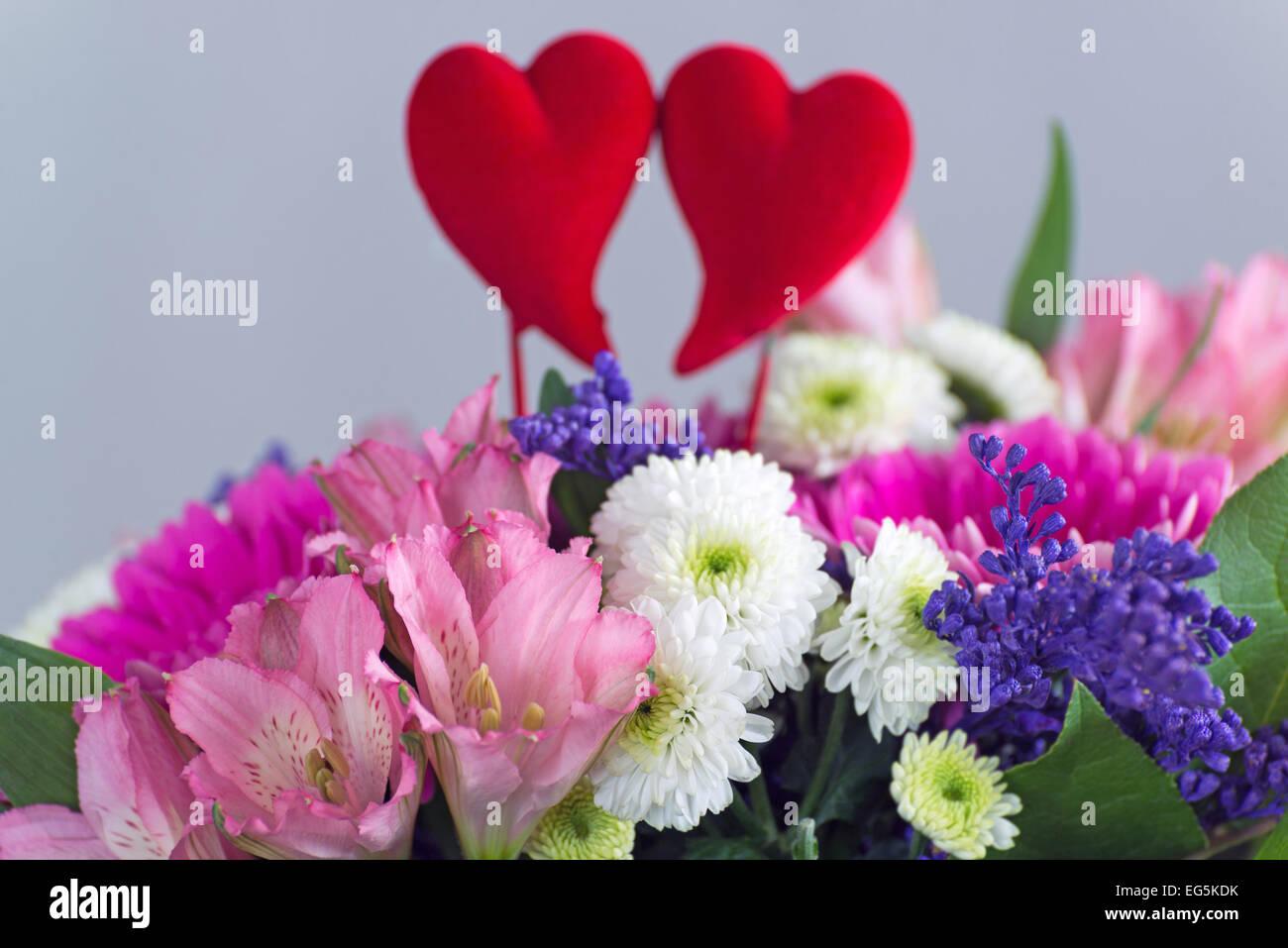 Red hearts and a bouquet of flowers Stock Photo - Alamy