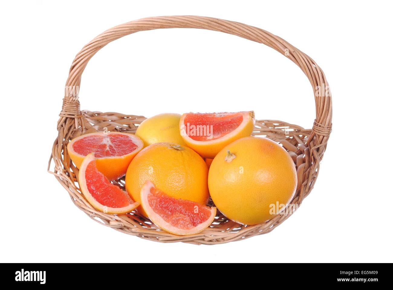 pink grapefruits in a straw basket, isolated on white Stock Photo - Alamy