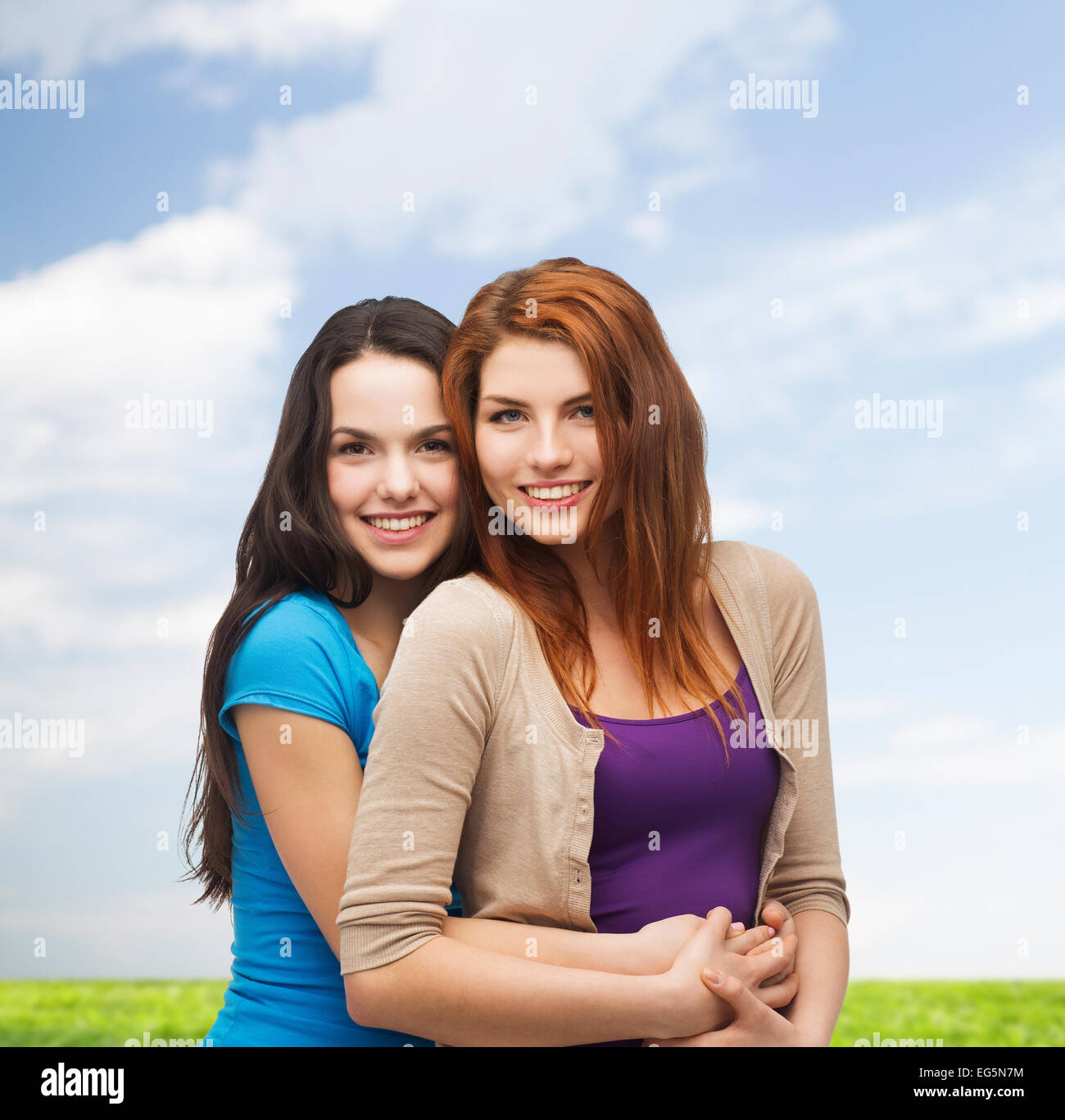 smiling teenage girls hugging Stock Photo - Alamy