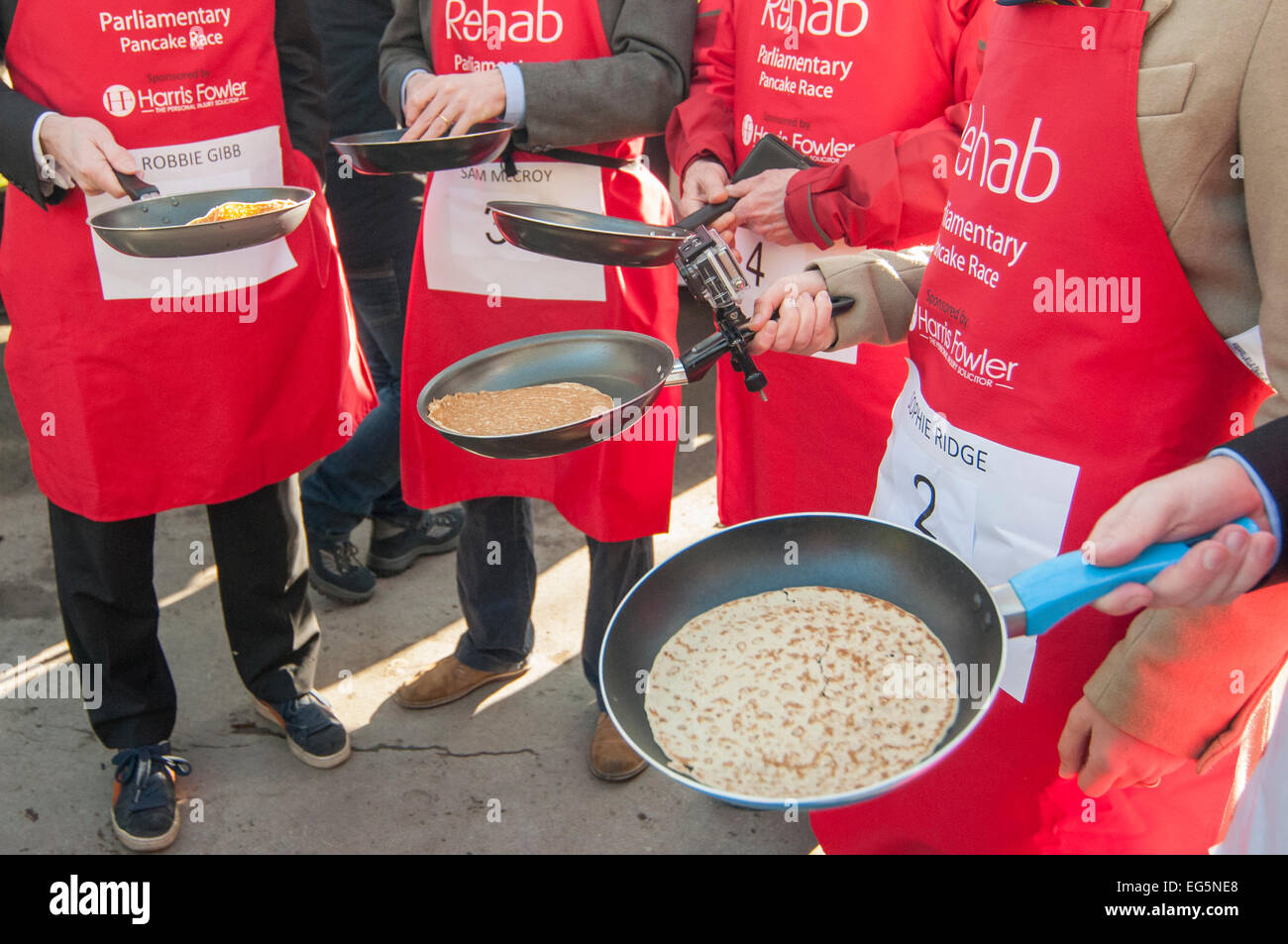 London, UK. 17th February, 2015.   MPs, Lords and members of the Parliamentary Press Gallery take part in the annual, charity Parliamentary Pancake Race in Victoria Tower Gardens, next to the Houses of Parliament on Shrove Tuesday. Pictured: the frying pans of the Media Team. Credit:  Stephen Chung/Alamy Live News Stock Photo
