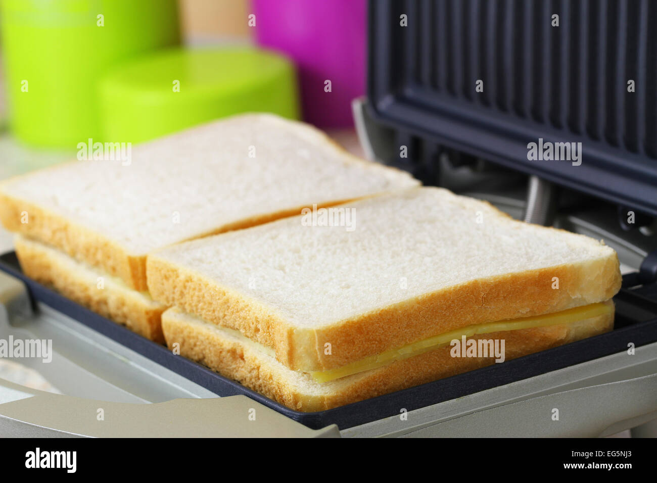 Toast with cheese and ham in toaster, closeup Stock Photo Alamy