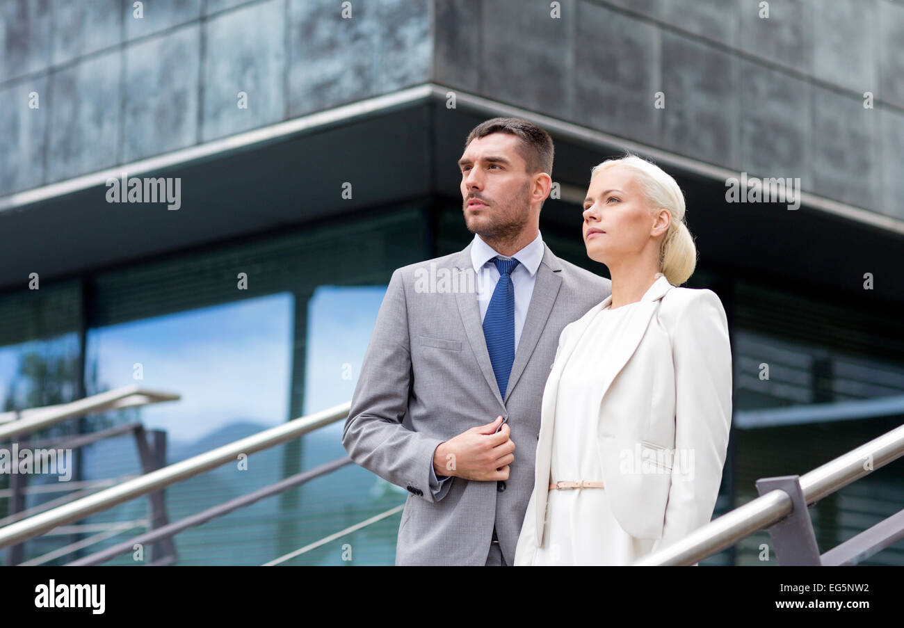 serious businessmen standing over office building Stock Photo - Alamy