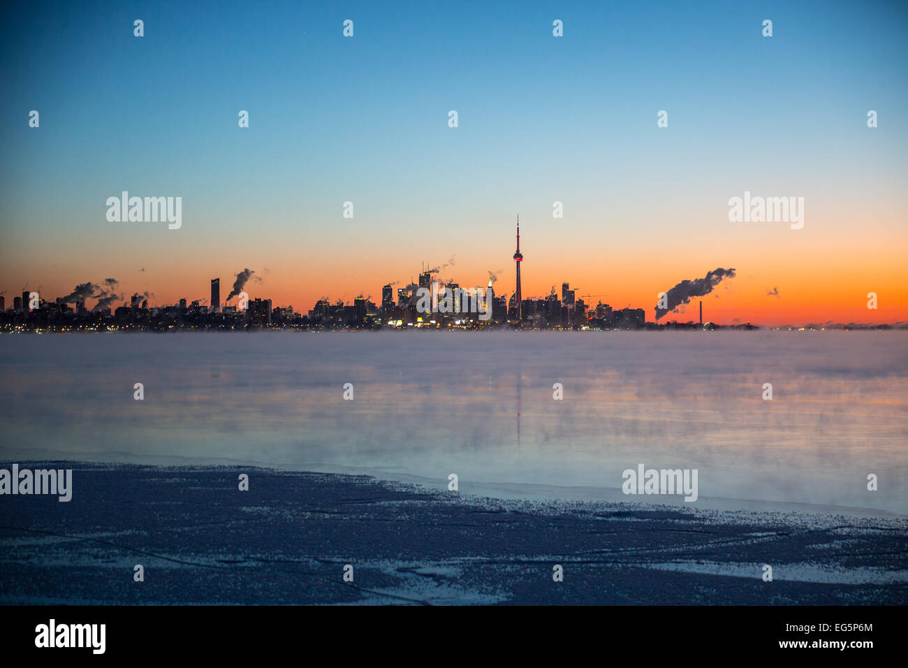 The pre-dawn frigid Toronto skyline with steaming waters off Lake Ontario as a -25C polar airmass engulfs eastern North America Stock Photo