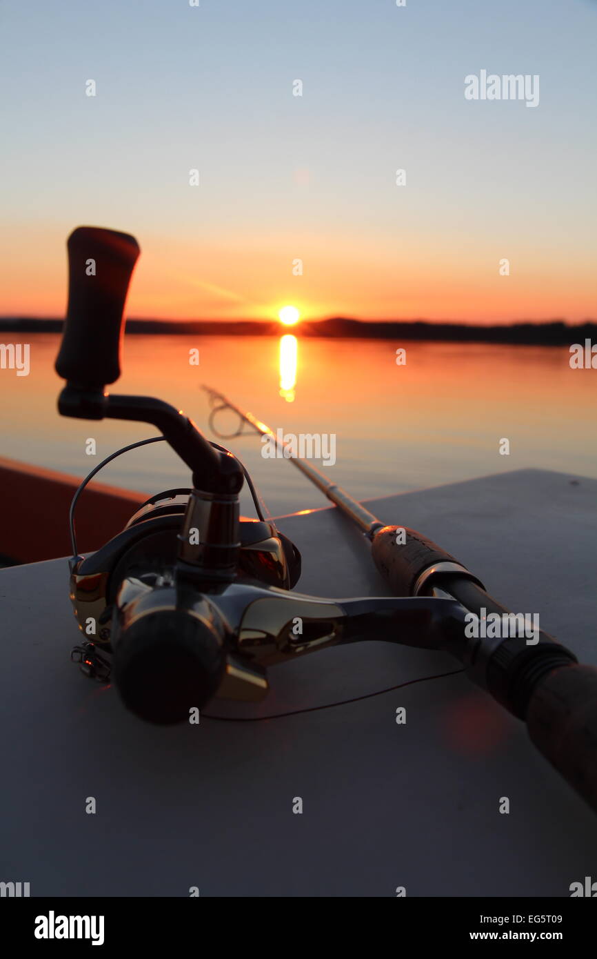 Fishing rod with an beautiful red sunset in the background Stock Photo -  Alamy