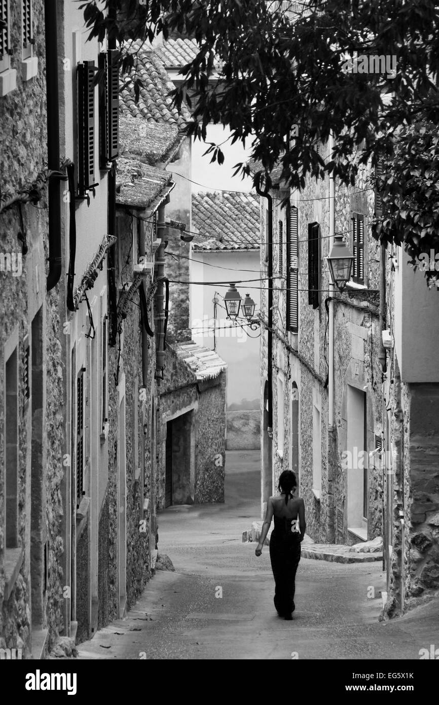 Old town street in spain, Spanish lady walking down a street in spain, traditional old town scene Stock Photo