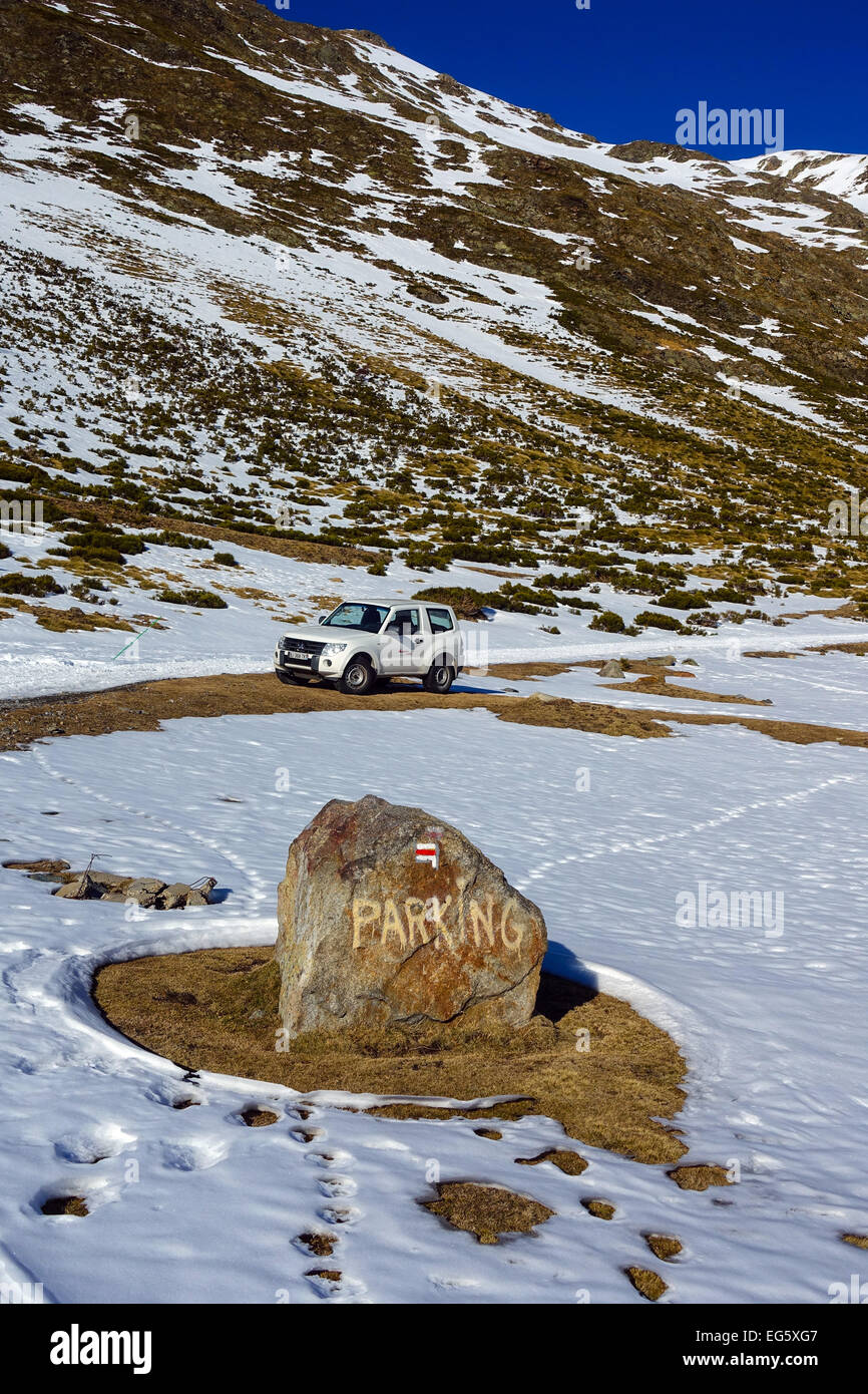 White 4x4 at parking space on snowy mountain with parking sign, in the wilderness, snow winter, off road, 4x4, 4 x 4, parking Stock Photo