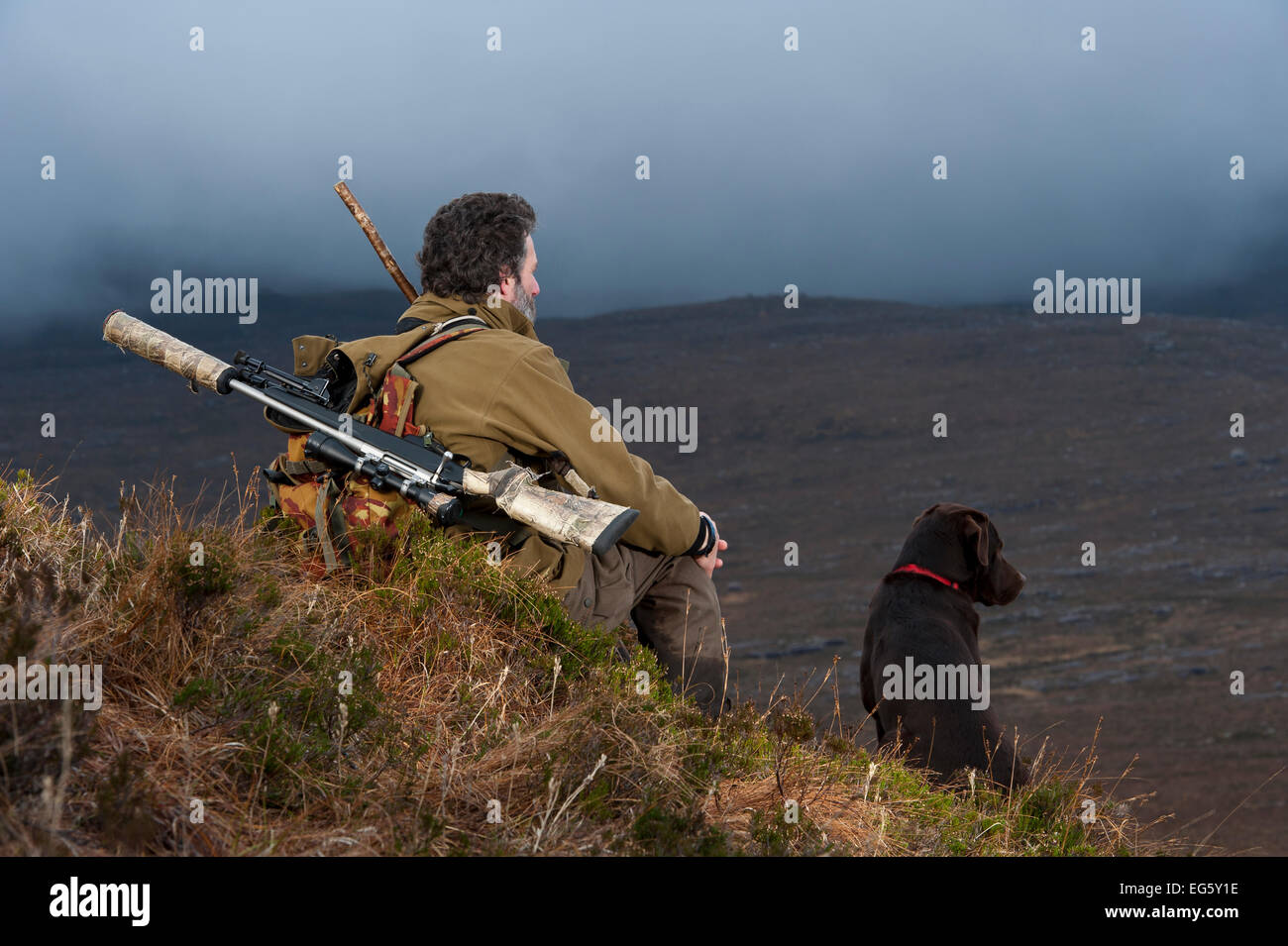 Don o’Driscoll, JMT, looking out over the moorland, with dog, Quinag, Sutherland, Highland, Scotland, UK, January 2011. 2020VISI Stock Photo