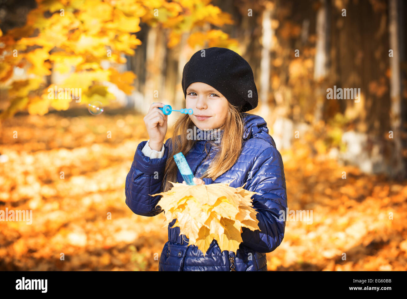 young girl in autumn park golden leaves Stock Photo - Alamy
