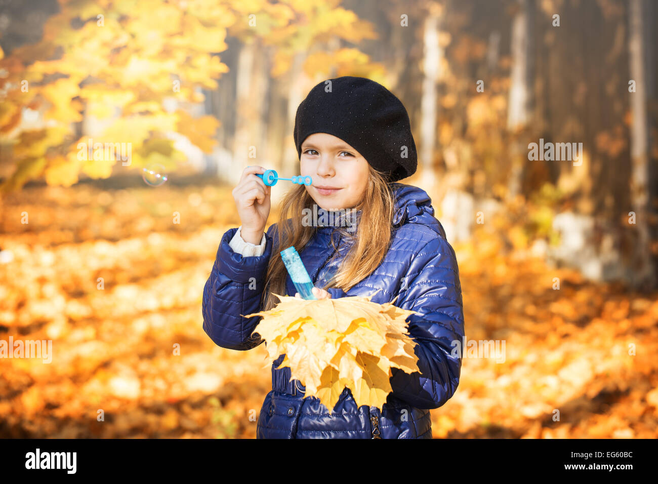 young girl in autumn park golden leaves Stock Photo - Alamy