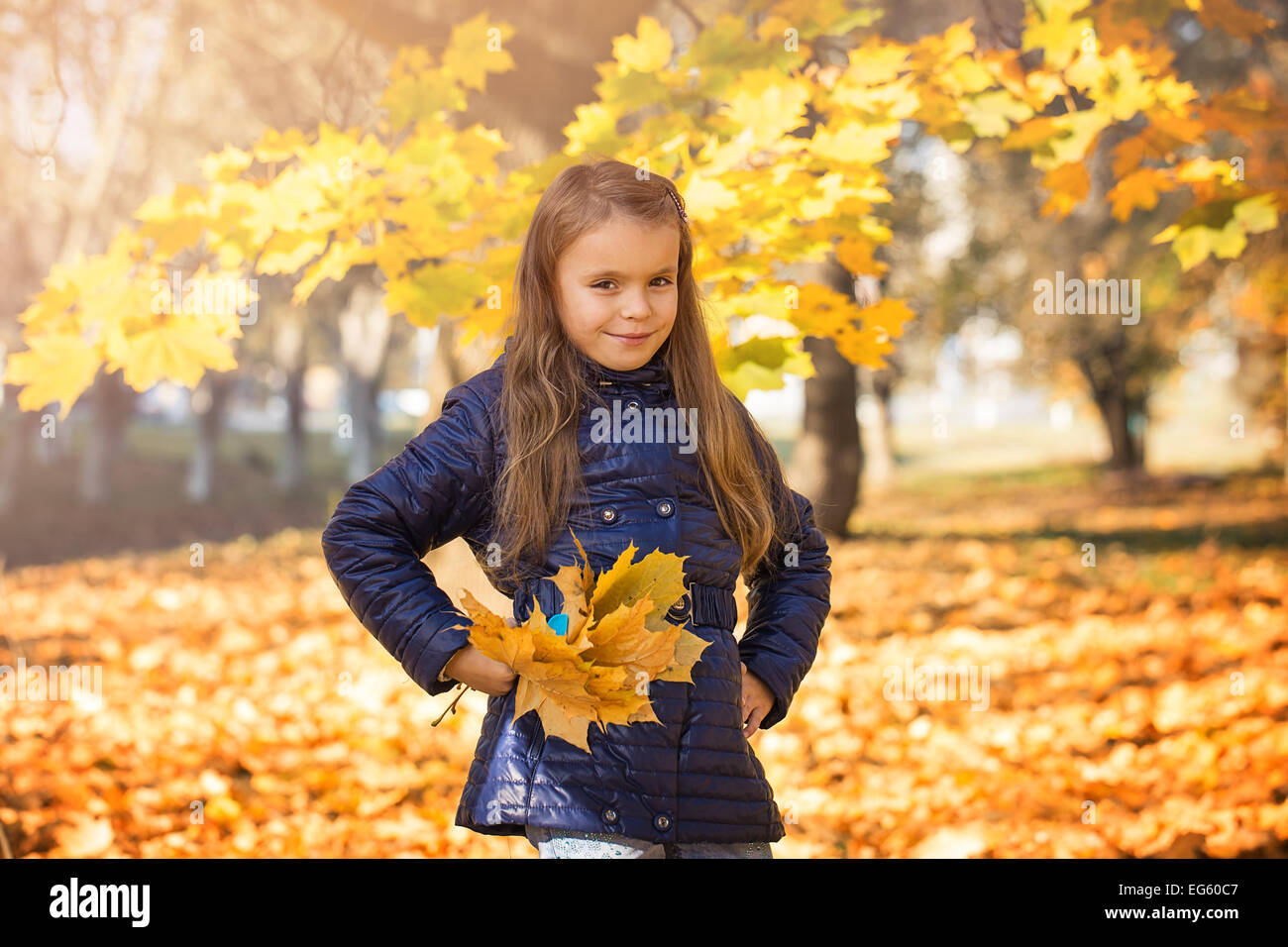 young girl in autumn park golden leaves Stock Photo - Alamy