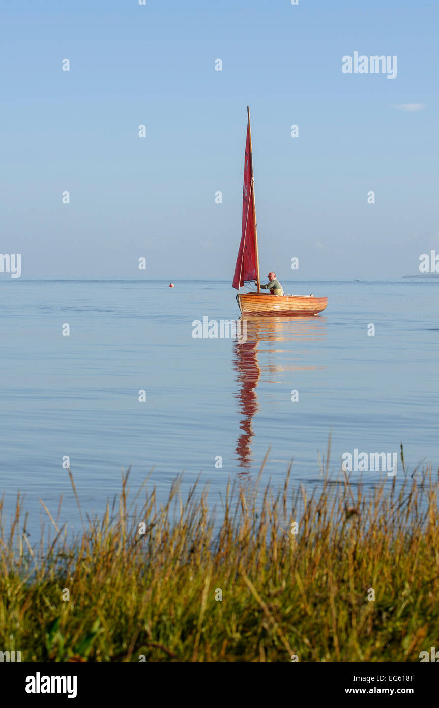 Small traditional sailing boat on the Thames Estuary, Two Tree Island, Essex, England, UK, October. Stock Photo