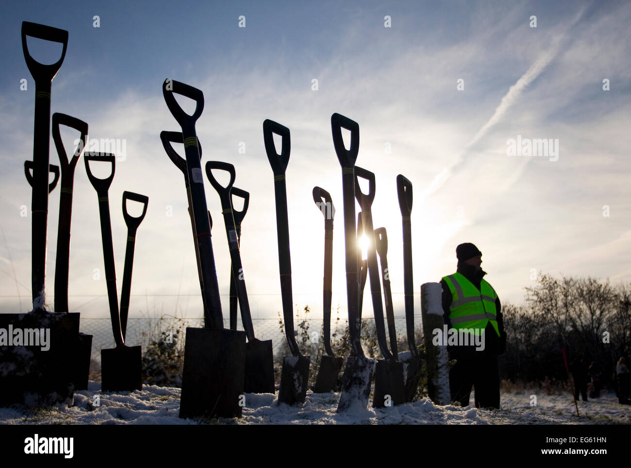 Man standing next to a group of spades stuck in the ground, part of The National Forest planting day, Moira, Derbyshire, England, UK, November 2010. 2020VISION Book Plate. Did you know? In 2013-2014, 149 hectares were added to the National Forest. Stock Photo