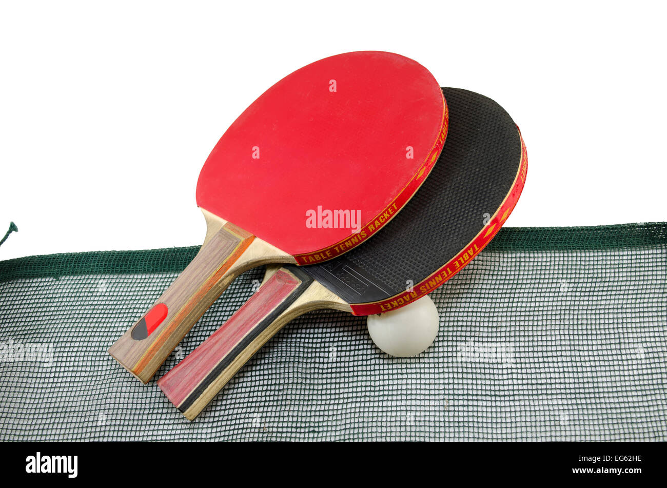 Red and black table tennis rackets with a ping-pong ball and a net on white Stock Photo