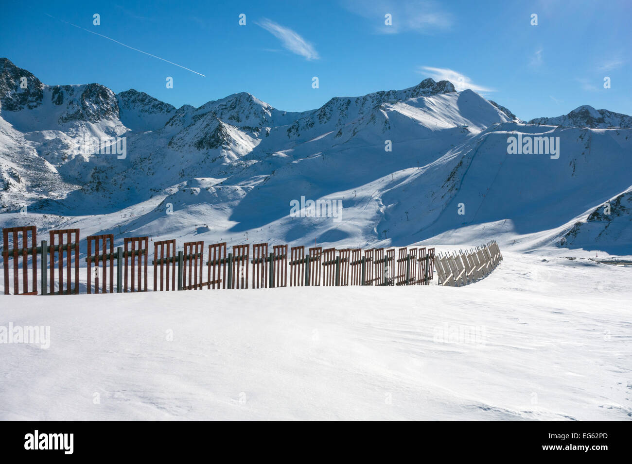Snow fence and snowy mountains, blue sky, ski resort, Pas de la Casa, Andorra Stock Photo