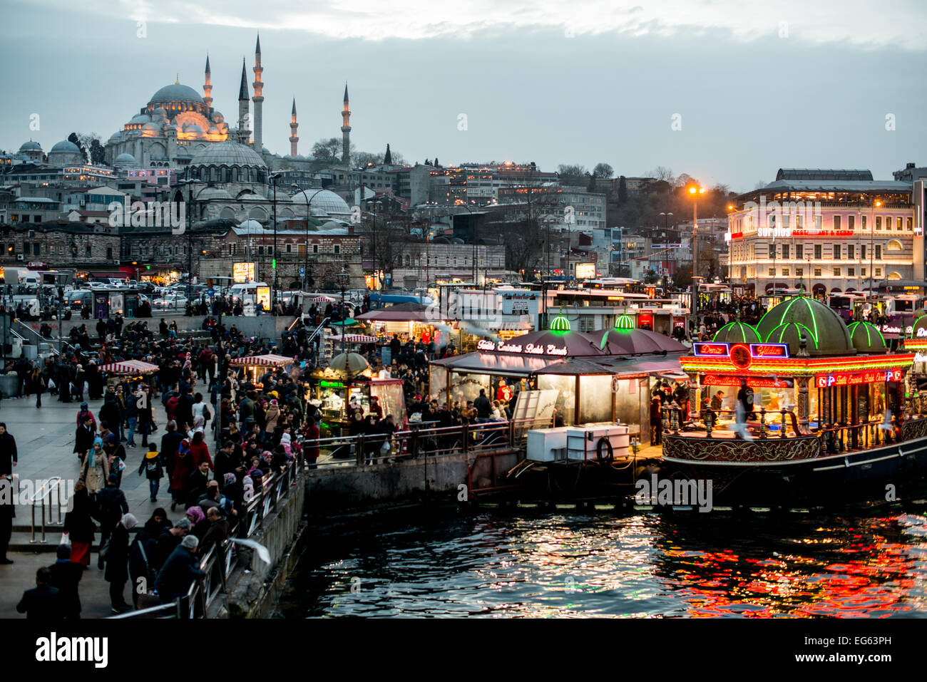 ISTANBUL, Turkey — ISTANBUL, Turkey — The busy waterfront district of Eminonu in Istanbul, at the foot of the Galata Bridge. Suleymaniye Mosque is in the background. A historic area with a rich Ottoman past, Eminonu is the heart of old Istanbul, where traders and tourists merge in a colorful spectacle of cultural exchange. Stock Photo