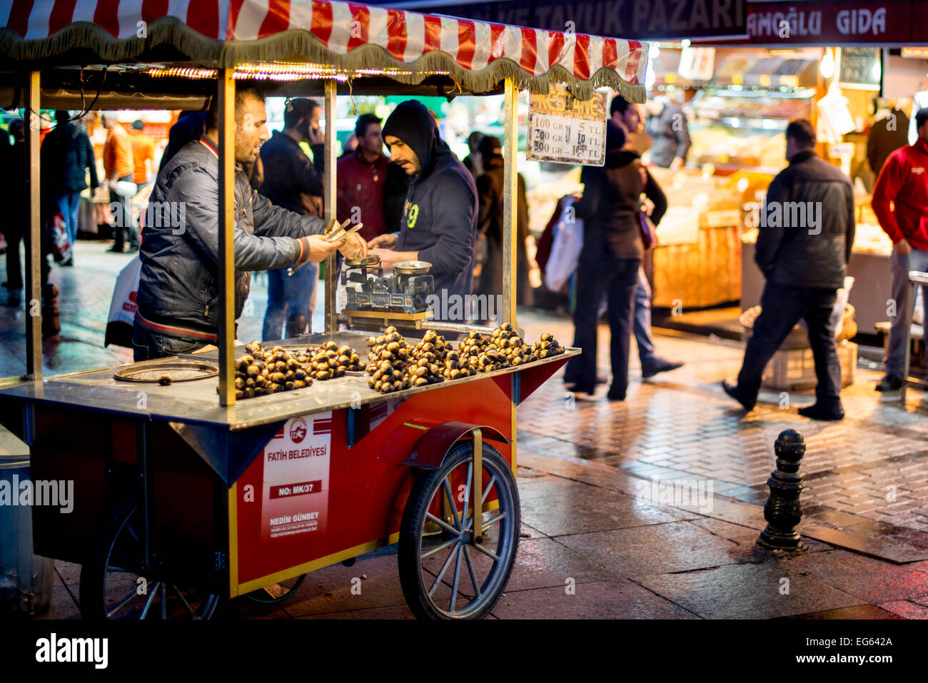 ISTANBUL, Turkey — ISTANBUL, Turkey — A man sells roasted chestnuts from his cart on the waterfront of the Eminonu district in Istanbul A historic area with a rich Ottoman past, Eminonu is the heart of old Istanbul, where traders and tourists merge in a colorful spectacle of cultural exchange. Stock Photo