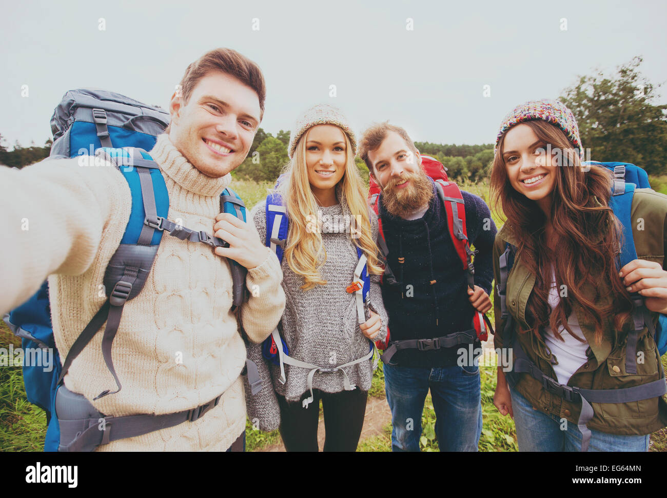 group of smiling friends with backpacks hiking Stock Photo - Alamy