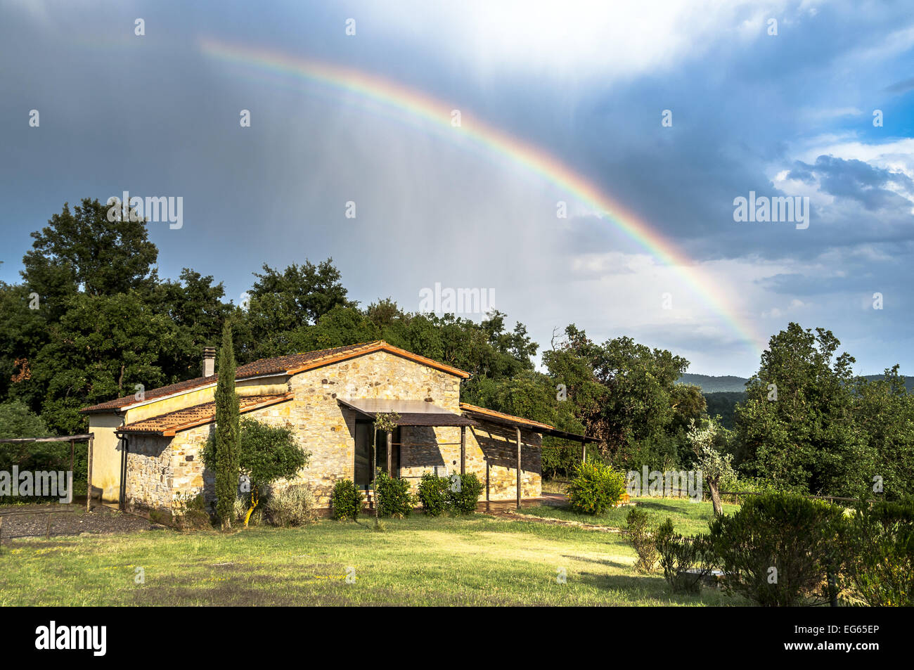 Rural cottage in Tuscany, italy, after a rainstorm, rainbow in the sky Stock Photo