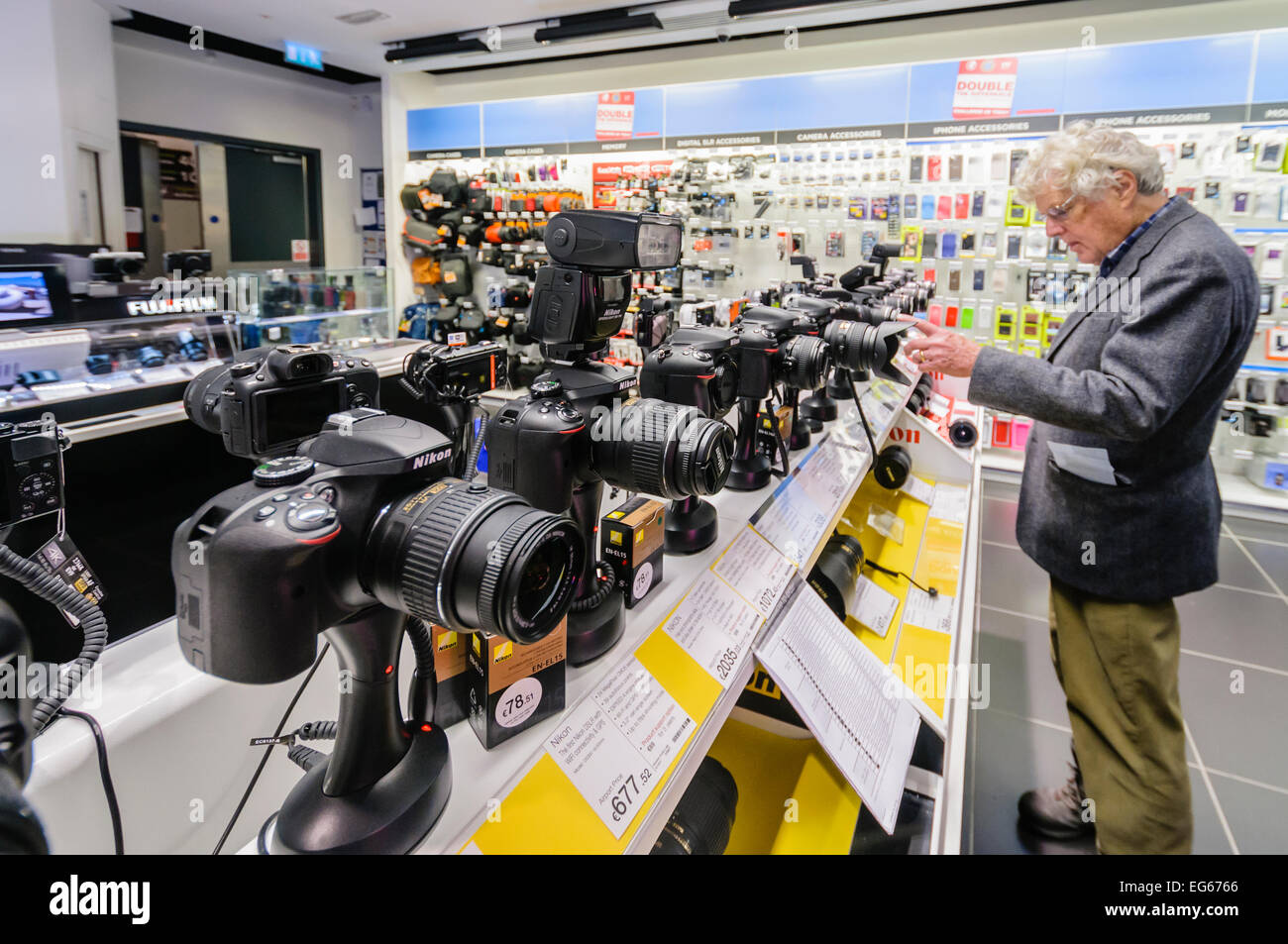 A man looks at cameras for sale in an electronics shop at an airport Stock Photo