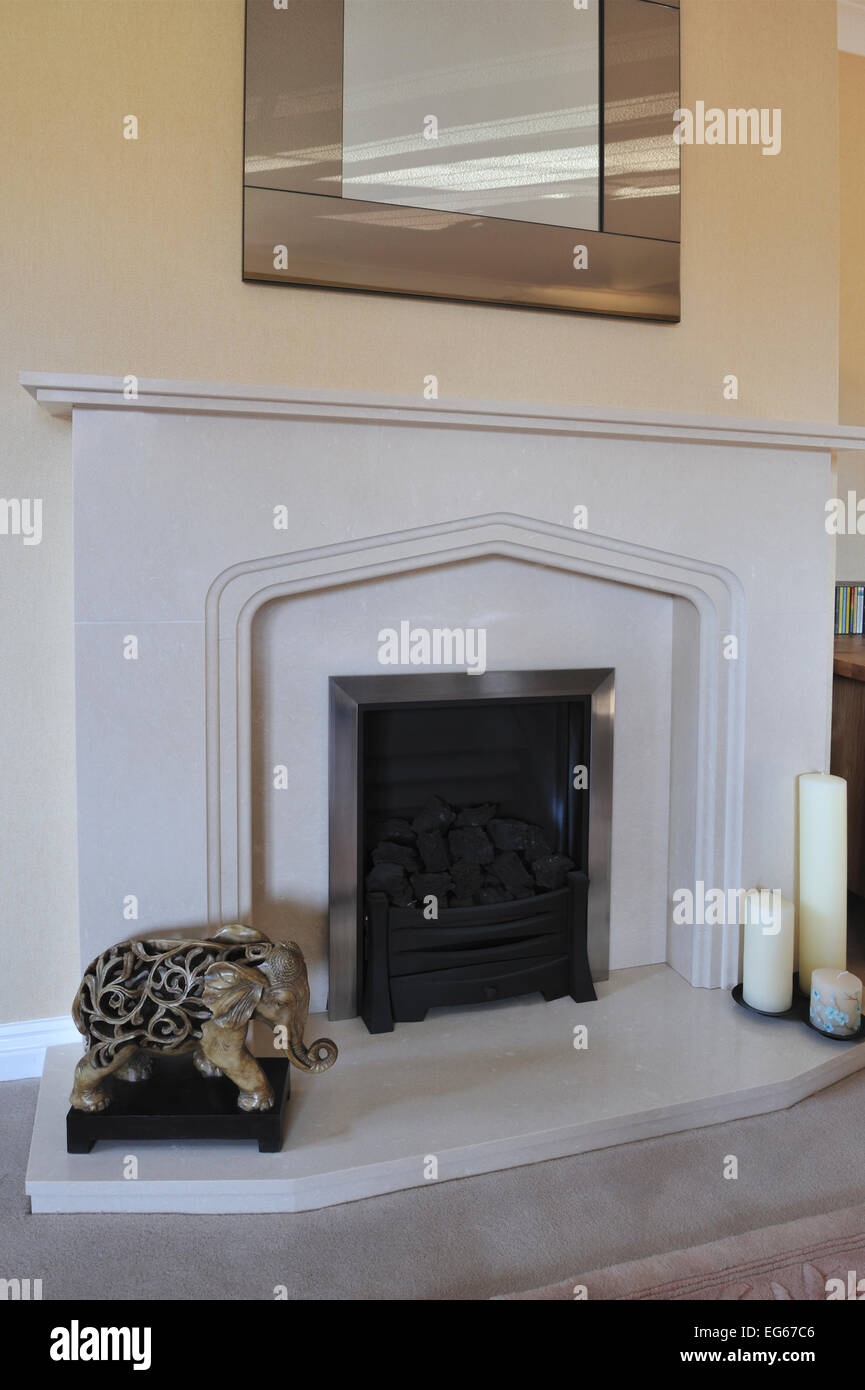 limestone fireplace in private living room Stock Photo