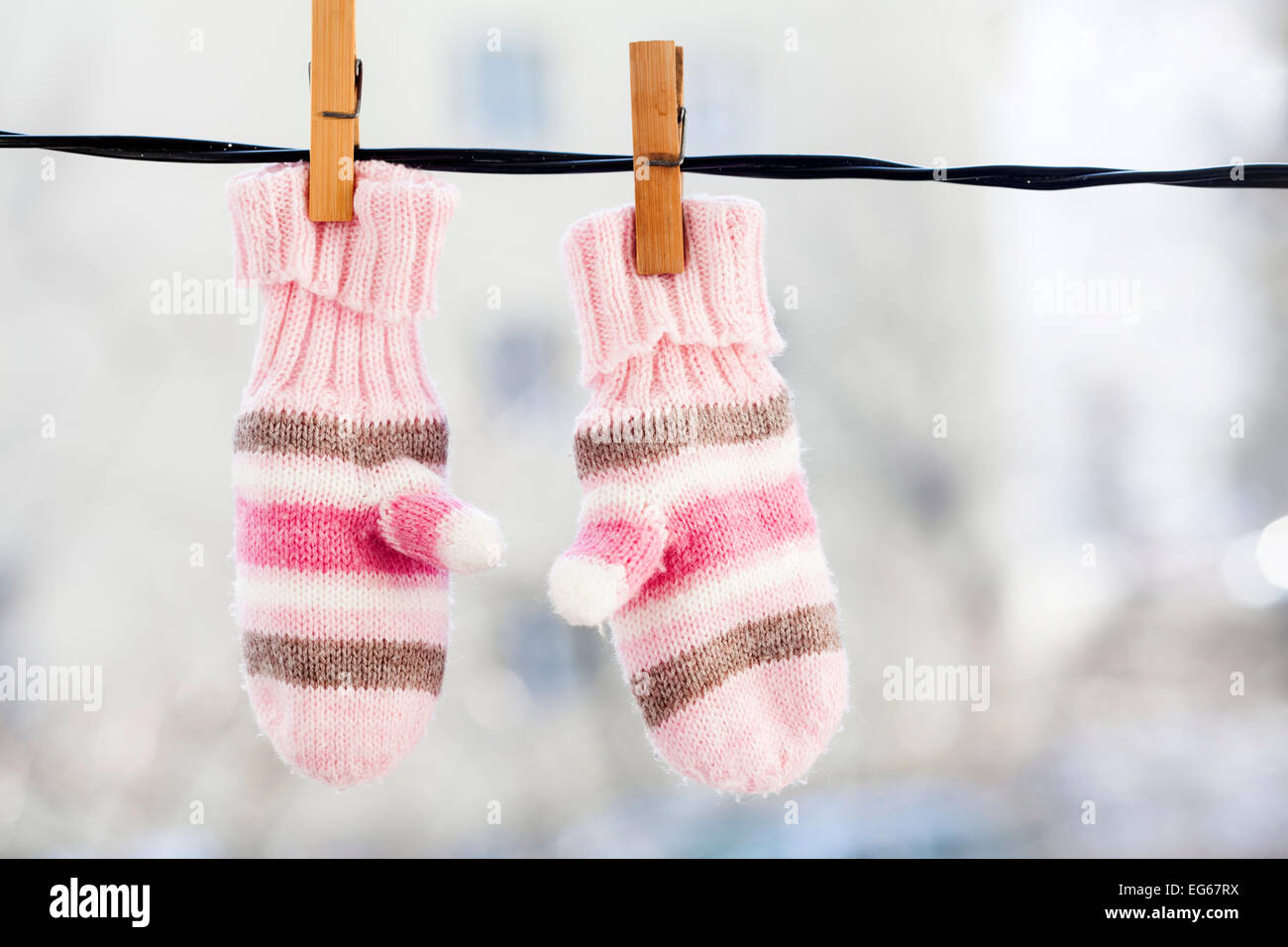 Baby gloves hanging on the clothesline. Stock Photo
