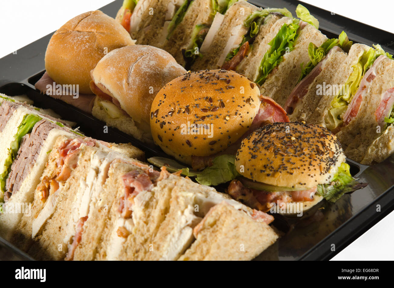 a plate of party food, wraps rolls and sandwiches Stock Photo