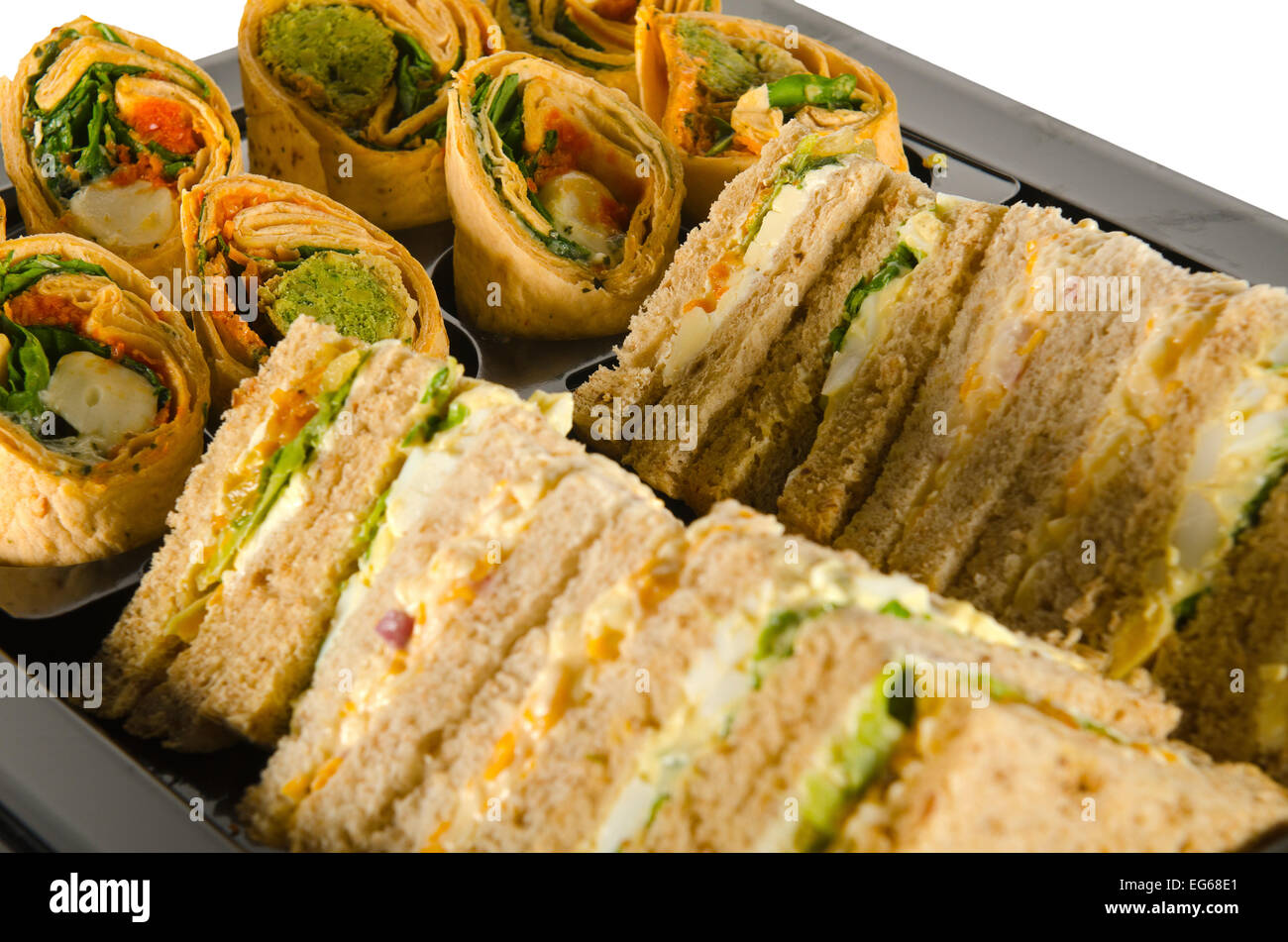 a plate of party food, wraps rolls and sandwiches Stock Photo