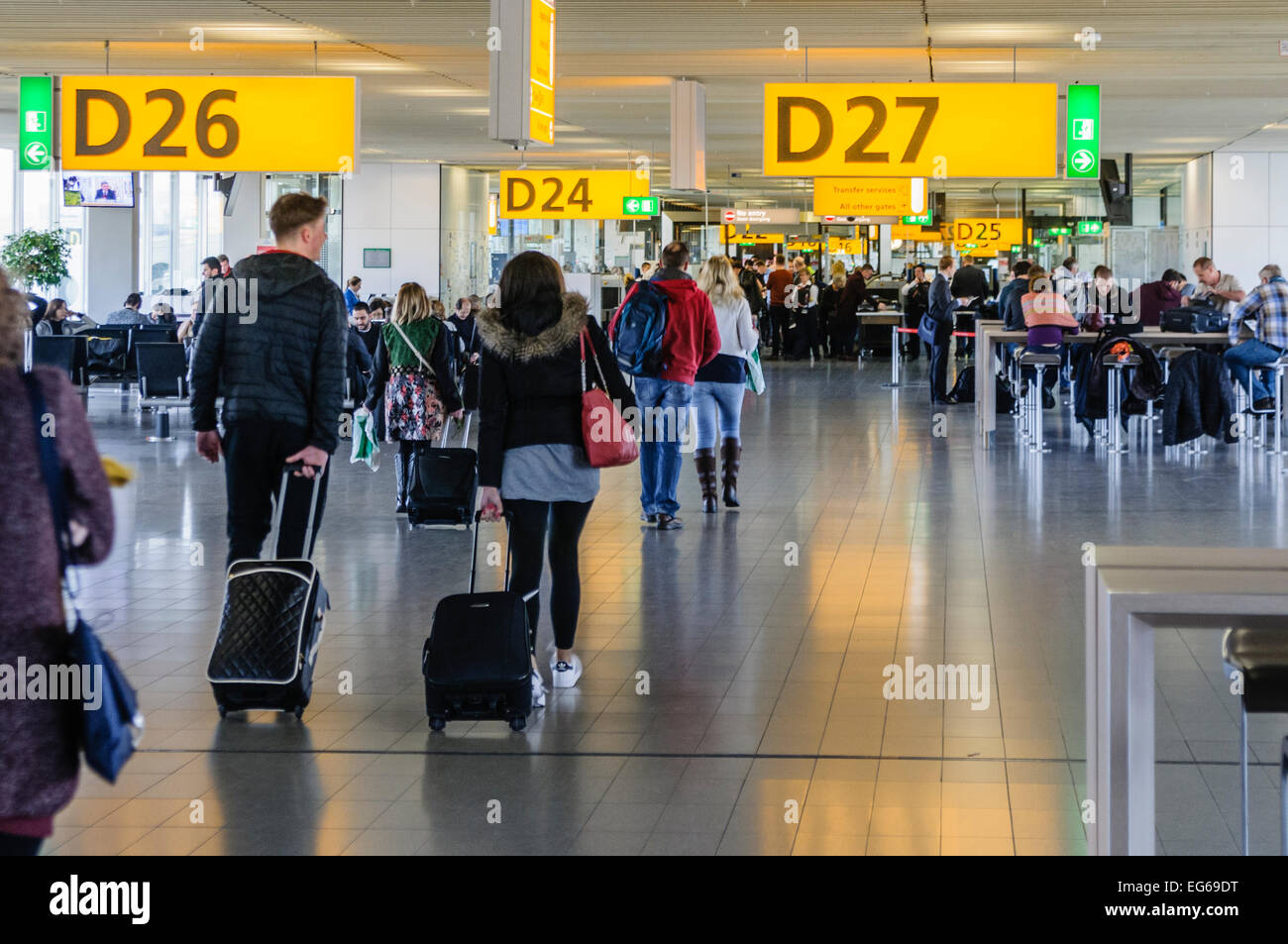 Passengers walk towards departure gates at Schiphol Airport, Amsterdam. Stock Photo