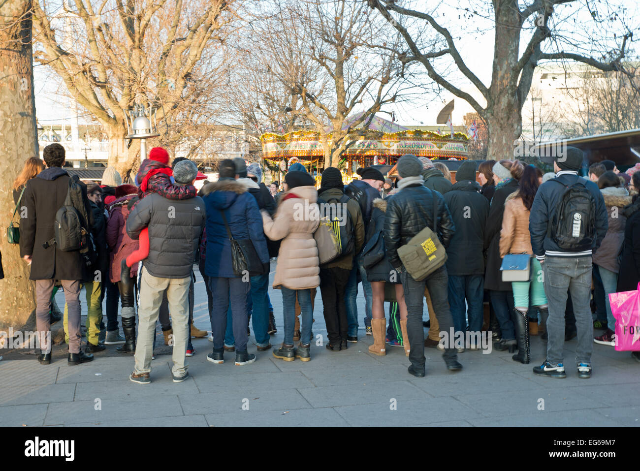 Back View of people watching entertainers at the Embankment London UK Stock Photo