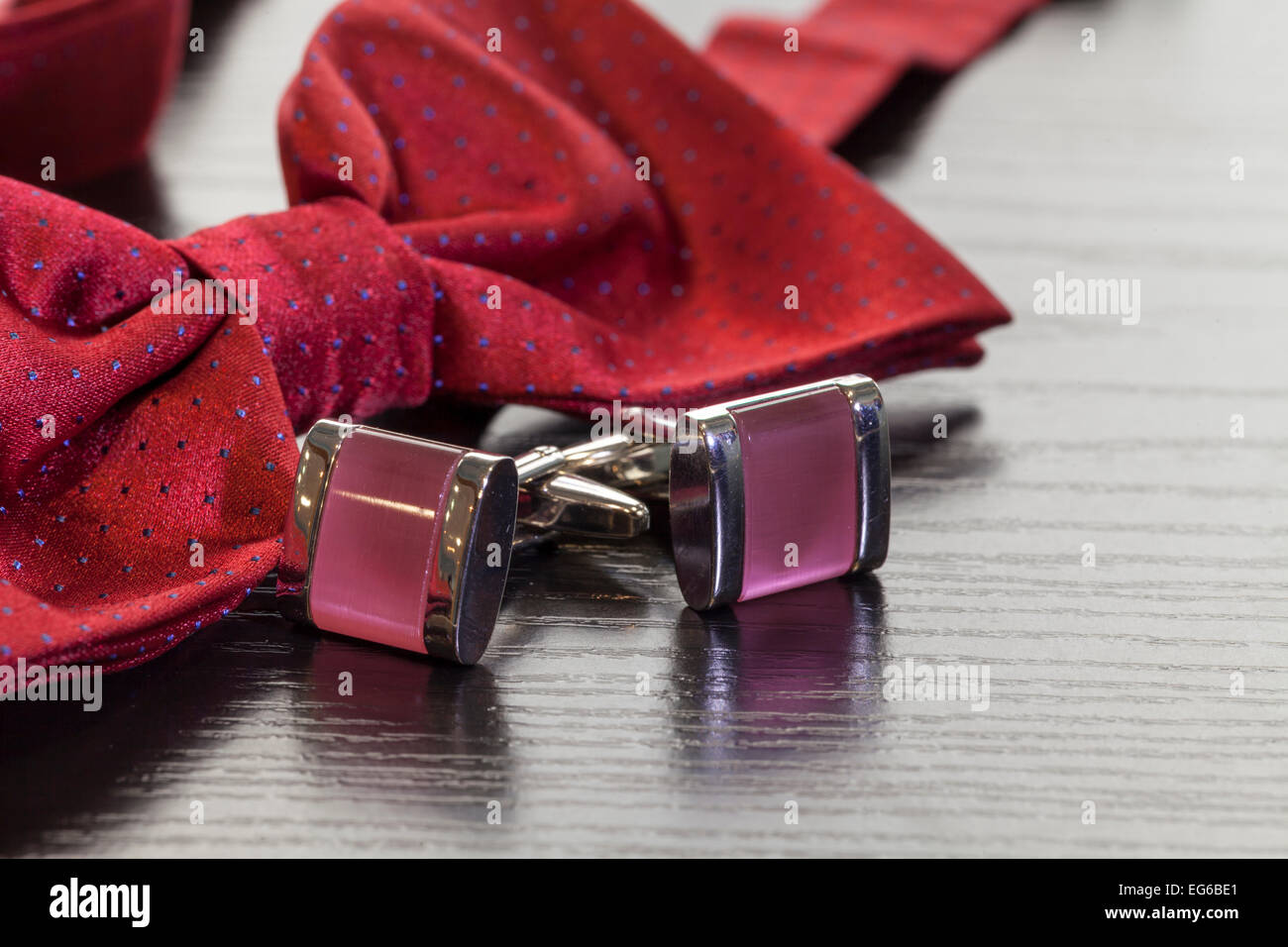 silver cuff links and red bow tie Stock Photo