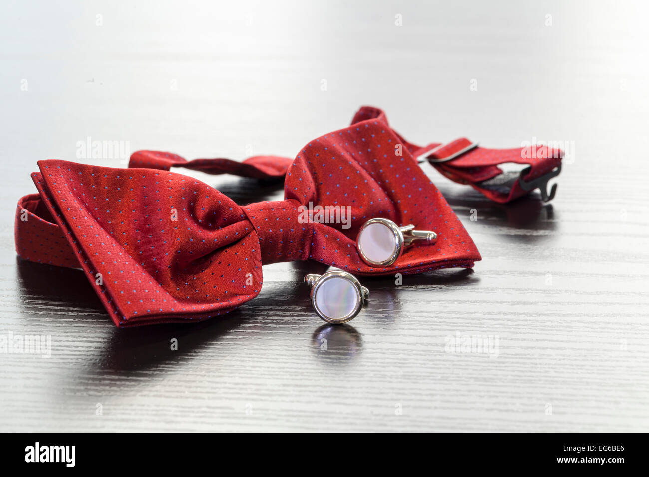 silver cuff links and red bow tie Stock Photo
