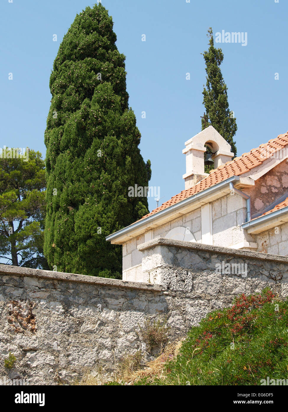 Chapel belfry and cypresses Stock Photo