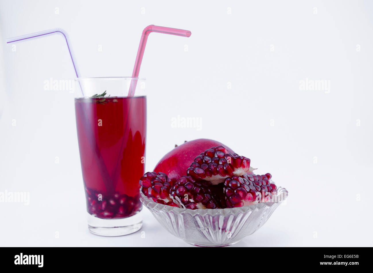 Pomegranate juice and fresh pomegranate on white background Stock Photo
