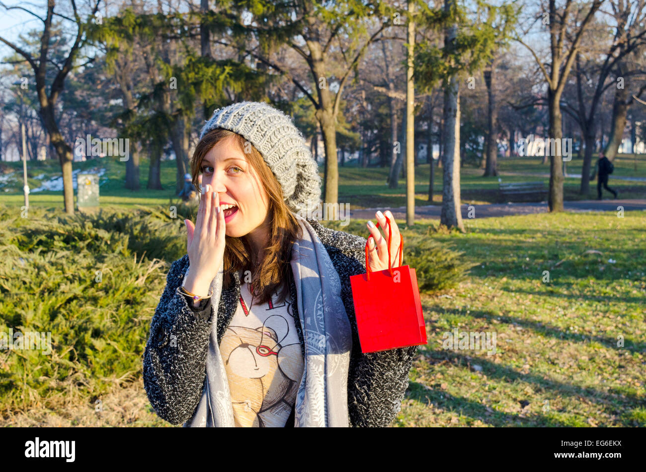 Surprised young girl opening a present for Valentines Stock Photo