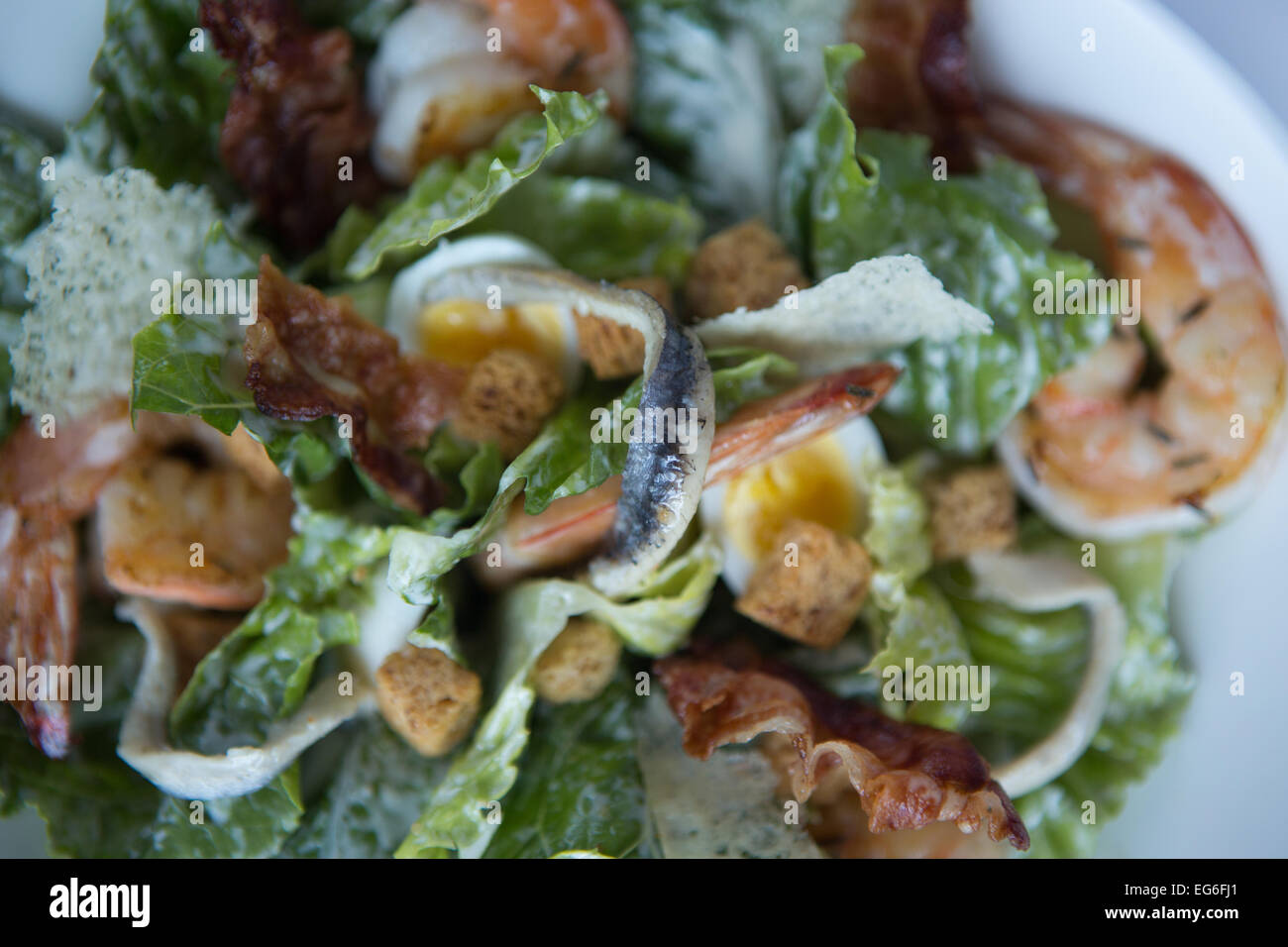 Prawn caesar salad with quails egg, pancetta and parmesan crisps Stock