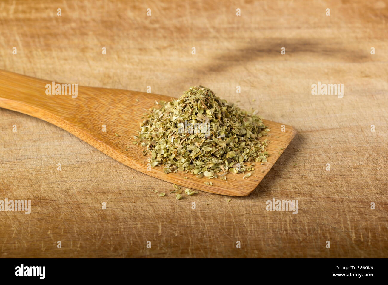 Oregano in a wooden spoon over wood background Stock Photo