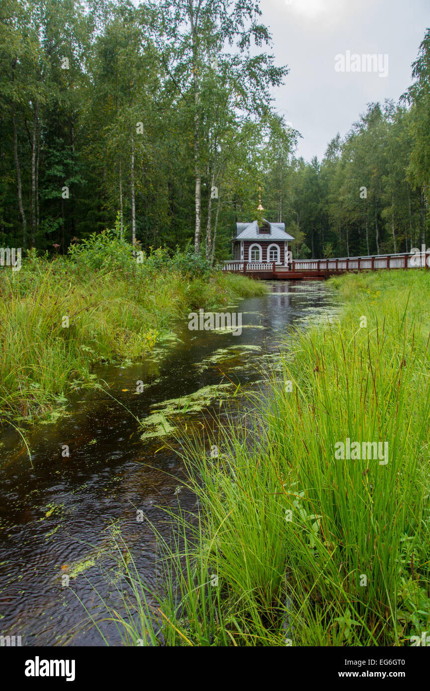 A place where begins the great Russian river Volga. This place boasts a beautiful wooden chapel. Stock Photo