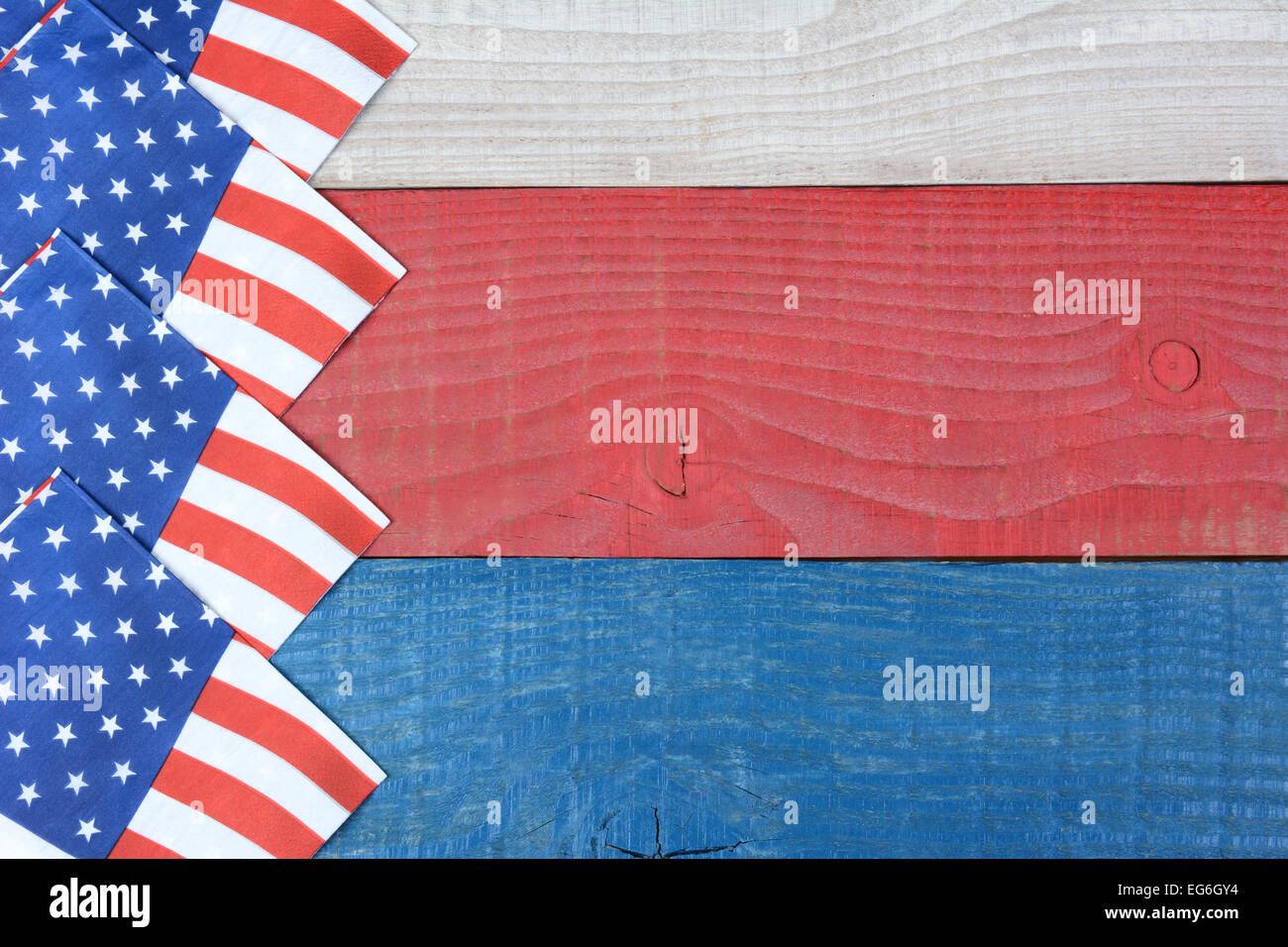 Overhead shot of American Flag napkins spread out on a red, white and blue picnic table. Horizontal format with copy space. Suit Stock Photo